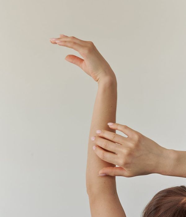 Woman in a graceful yoga pose with purple light accents.